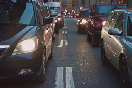 Analyse complète du parc automobile en France : composition et tendances actuelles A congested city street lined with cars stuck in traffic at dusk, showcasing urban life.